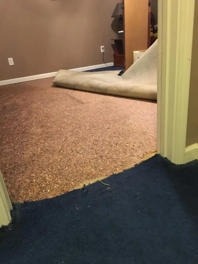 Carpet pad removal revealing water damage during Water Mitigation Services in Hattiesburg